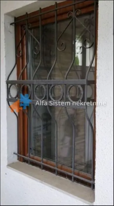 Close-up view of a window with protective metal bars.