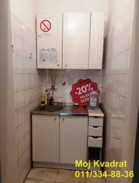 Small kitchen with a sink, cabinets, and wall tiles. - image 7