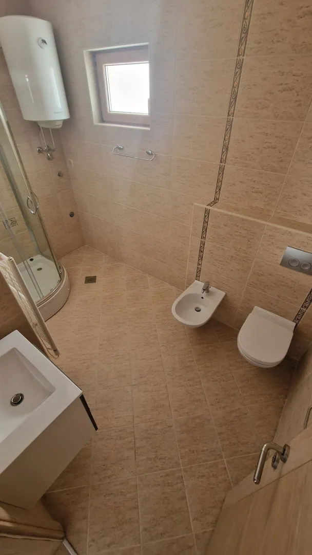 Bathroom equipped with a shower cabin, washbasin, bidet, and toilet.