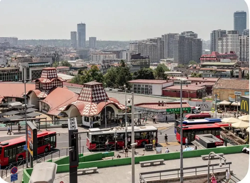 Window view of the cityscape with a street and buildings.