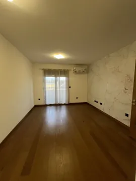 An empty room with wooden floors and a decorative accent wall. - image 9