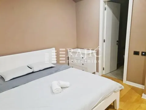 Furnished bedroom with a double bed and dresser. - image 6
