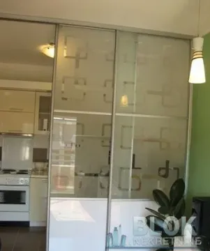 View from another room into the kitchen separated by sliding glass doors. - image 9