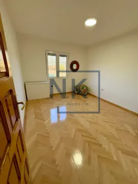 Empty room with hardwood flooring and a window. - image 9