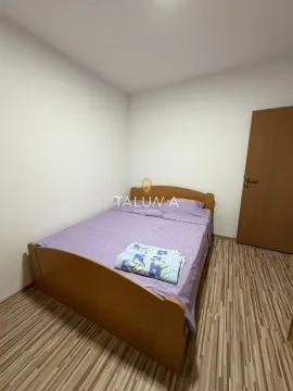 Bedroom with a double bed and wooden flooring. - image 12