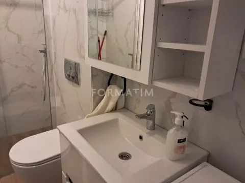 View of the bathroom with a vanity sink, mirrored cabinet, toilet, and shower enclosure. - image 8