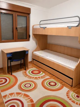 Children's bedroom with a bunk bed, desk, and a window. - image 5
