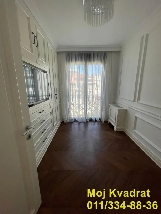 Smaller bedroom with built-in wardrobes and access to the terrace.