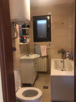 A functional bathroom with a bathtub, sink, and toilet. - image 10