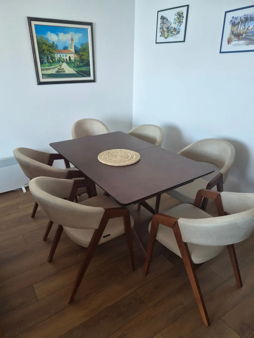 Dining area with a wooden table and modern chairs.