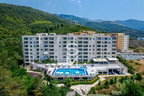 Aerial view of a residential complex with a swimming pool at the foot of the mountain. - image 2