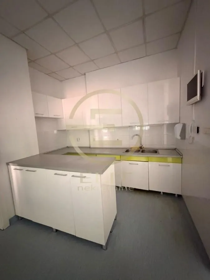 Kitchen equipped with white cabinets and an L-shaped countertop.