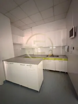 Kitchen equipped with white cabinets and an L-shaped countertop. - image 6