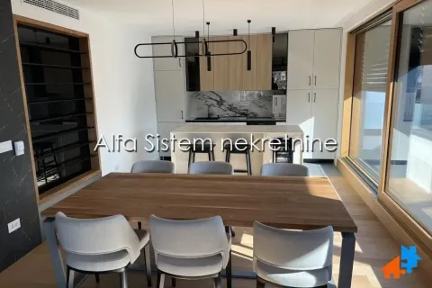 Modern kitchen with a dining area and built-in units. - image 3