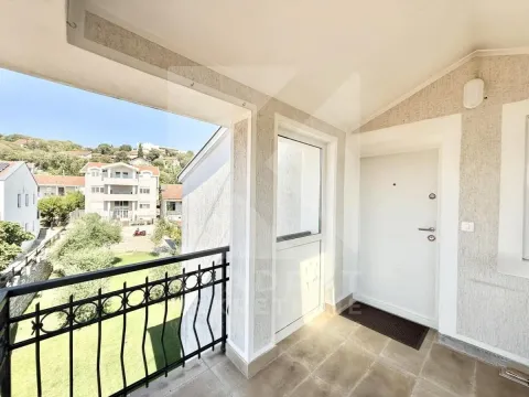 Covered balcony with an entrance door and a view of the surroundings. - image 11
