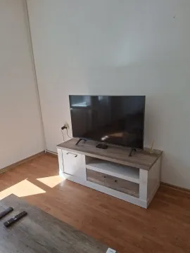 Bright space with a TV on a modern stand. - image 8
