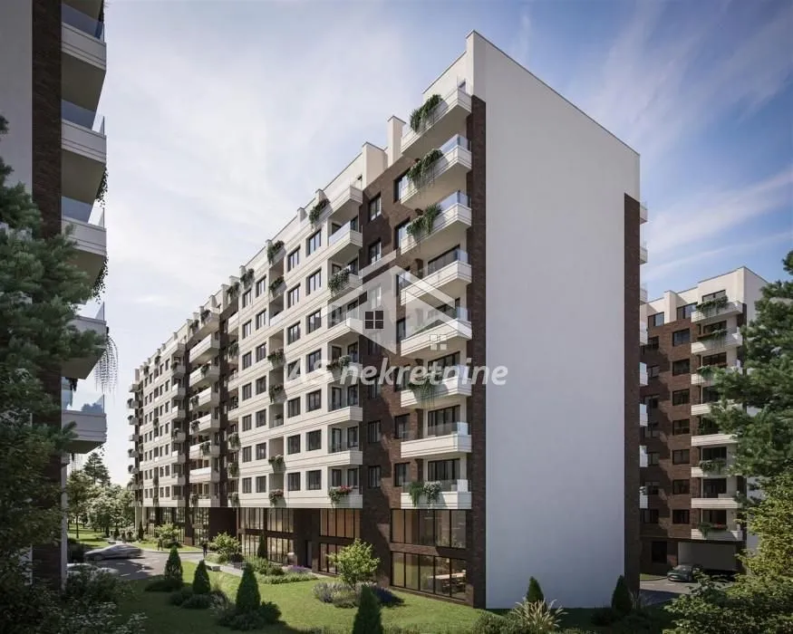 Exterior view of a modern residential building with balconies and landscaped courtyard.