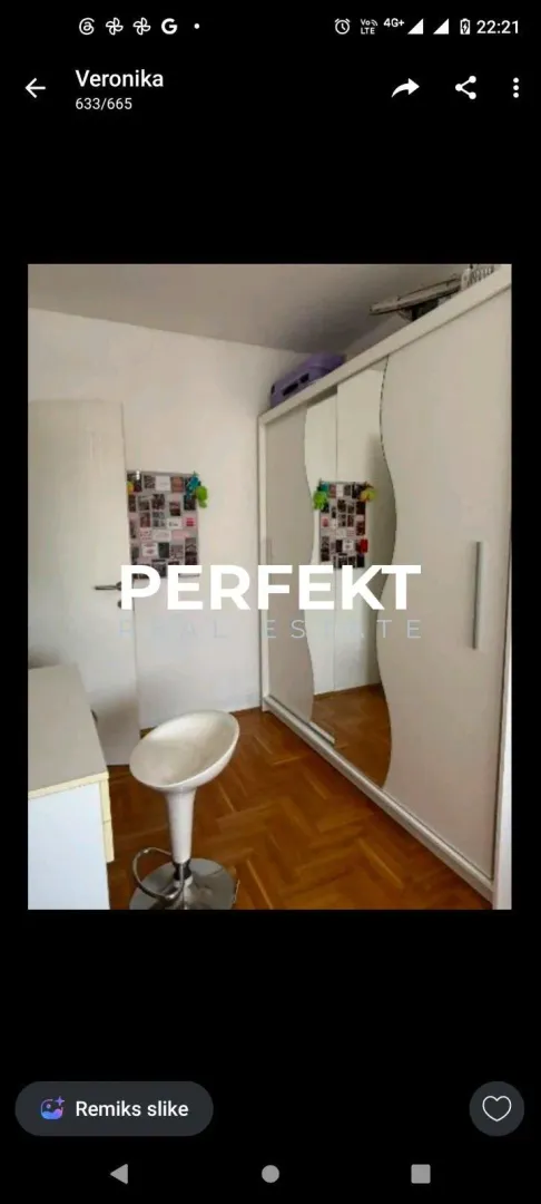 Smaller bedroom with a large mirrored wardrobe and a desk.