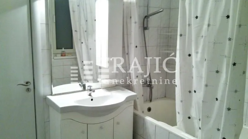 Small bathroom with a sink and bathtub.