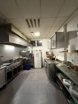 Commercial kitchen with stainless steel units and professional equipment. - image 2