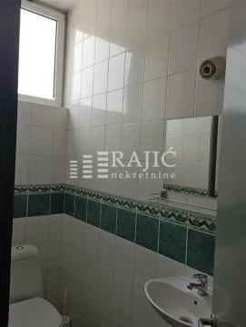 Small bathroom with white and green tiles. - image 8