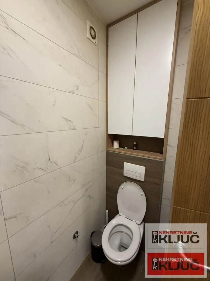 Manje kupatilo sa ugradnom wc šoljom i visećim elementom.