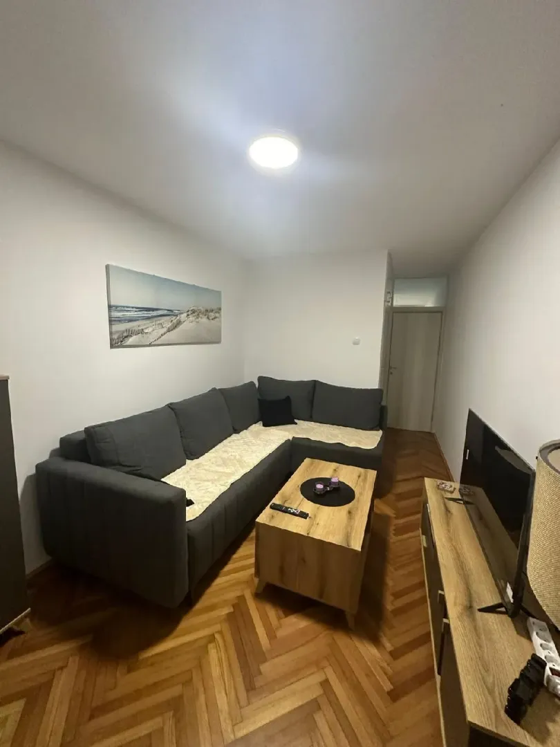 Living room with a sectional sofa, coffee table, and TV.