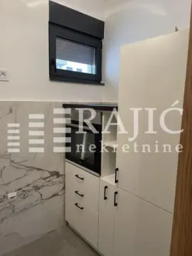 Small white kitchen with a built-in oven. - image 3
