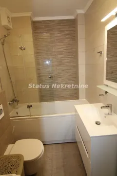 Modernly equipped bathroom with bathtub, shower screen, washbasin and toilet. - image 15