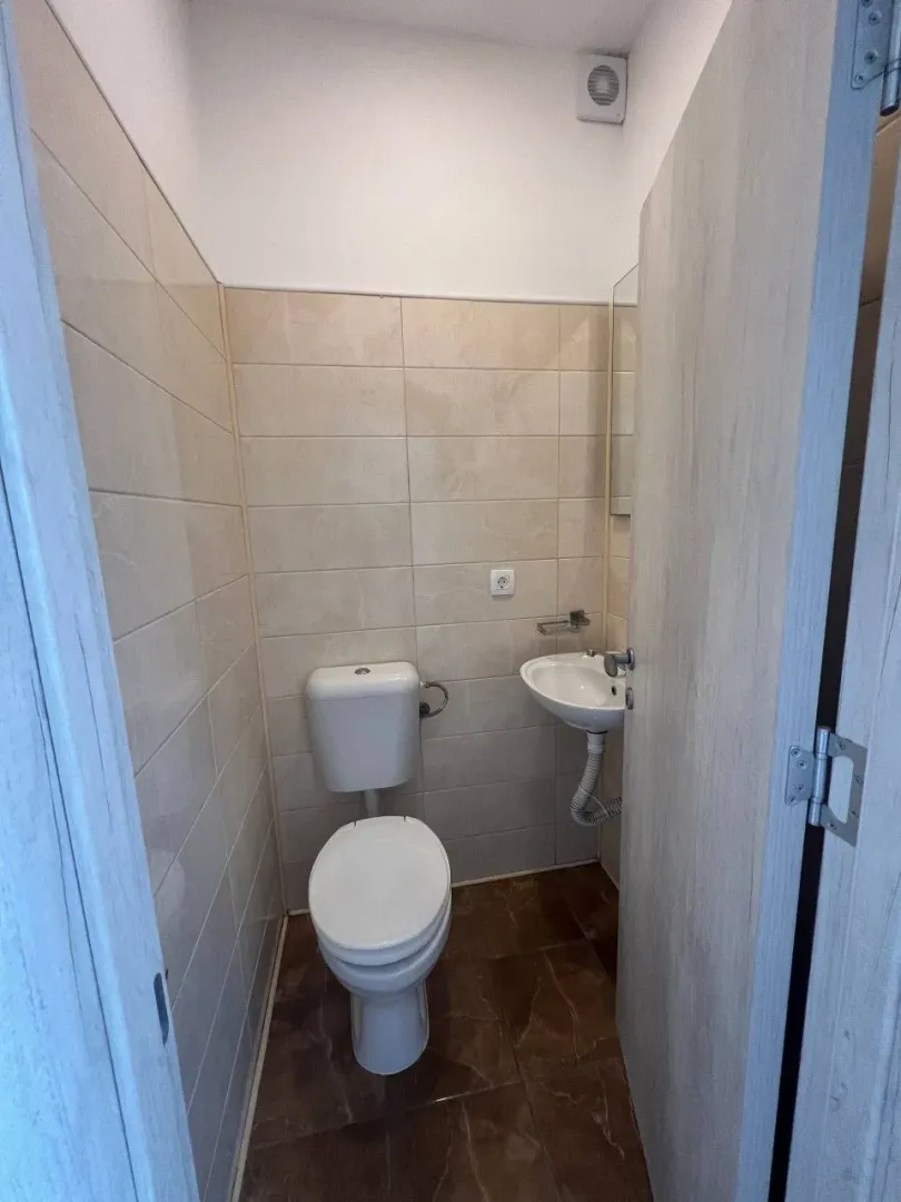 Small bathroom with a toilet and a sink.