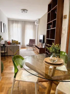 Living room with a dining area and seating set. - image 3