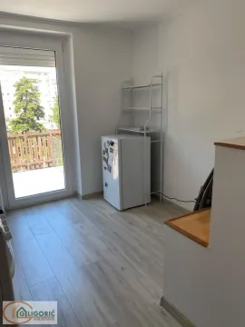Small kitchen with a refrigerator and access to the terrace. - image 11
