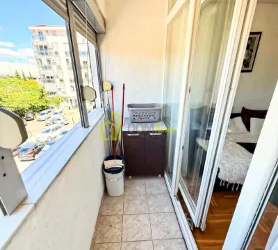 Zastakljeni balkon sa pločicama i pogledom na ulicu. - image 4