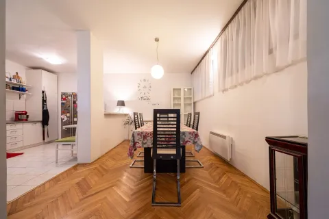 Dining area with a table and chairs and a view of the kitchen. - image 7