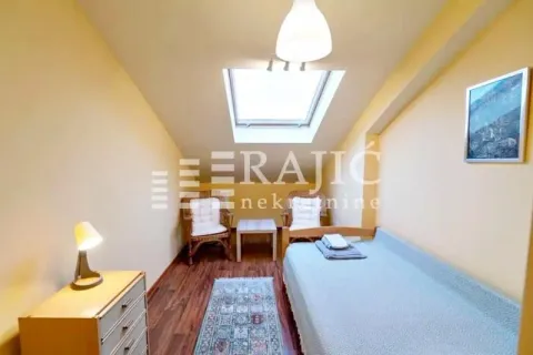 Small bedroom with a bed, dresser, and roof window in the attic. - image 15