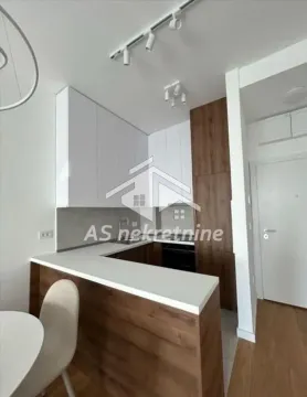 Modern U-shaped kitchen with white cabinetry and wooden details. - image 6