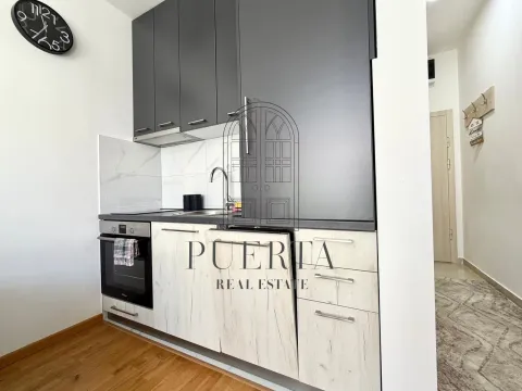 Modern kitchen with dark upper cabinets and light lower cabinets. - image 4