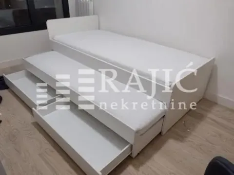 White pull-out bed in a bedroom. - image 9