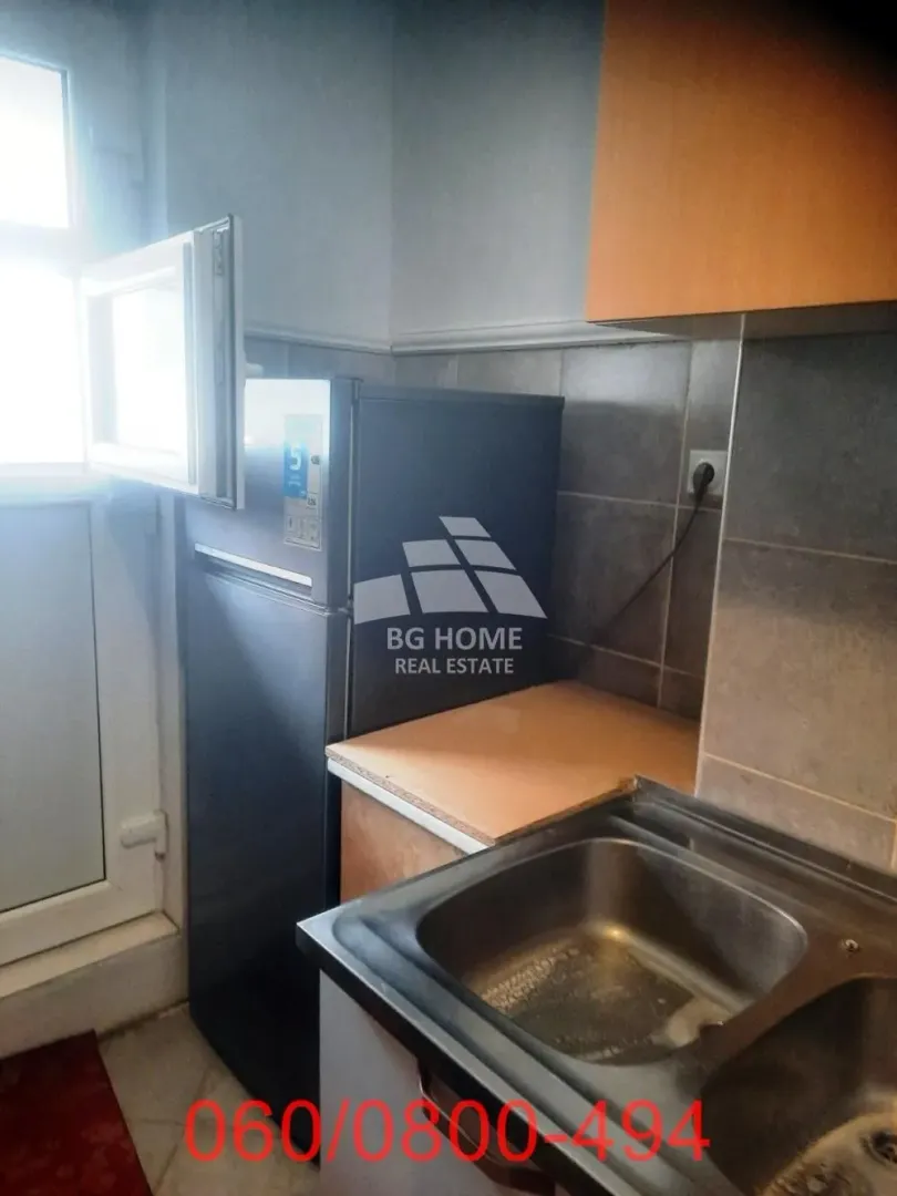 Smaller kitchen with a sink, countertops and a refrigerator.