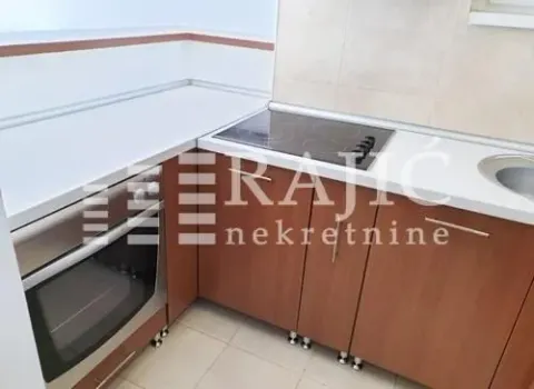 Small kitchen with a built-in oven, stovetop, and sink. - image 9