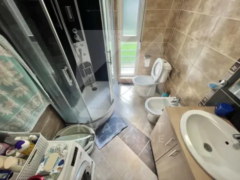 Bathroom equipped with a shower cabin, washbasin, toilet, bidet, and washing machine. - image 10