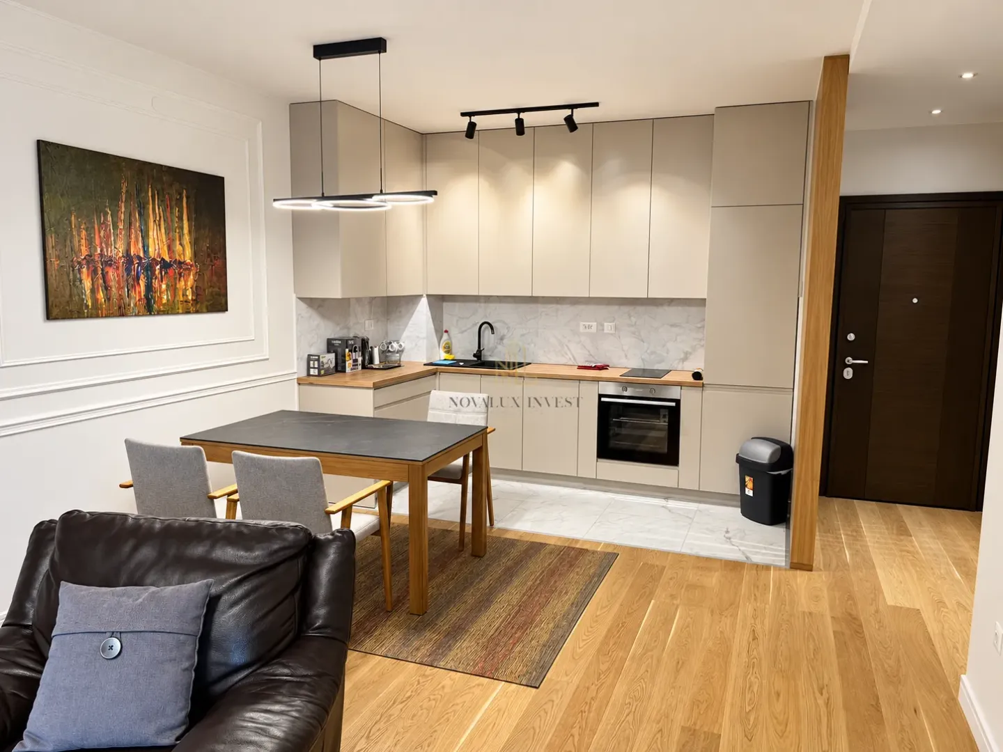 Modern kitchen with dining area and built-in appliances.