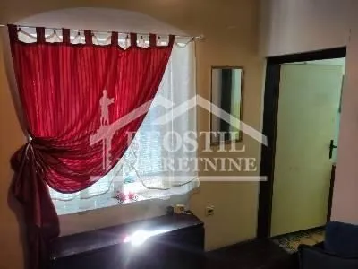 View of a part of the living room with a window and a red curtain. - image 4