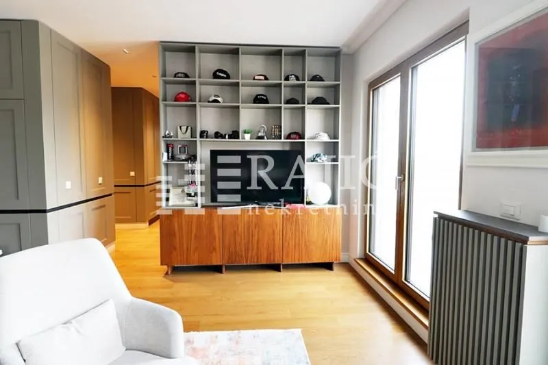 Living room with a TV unit and shelves.
