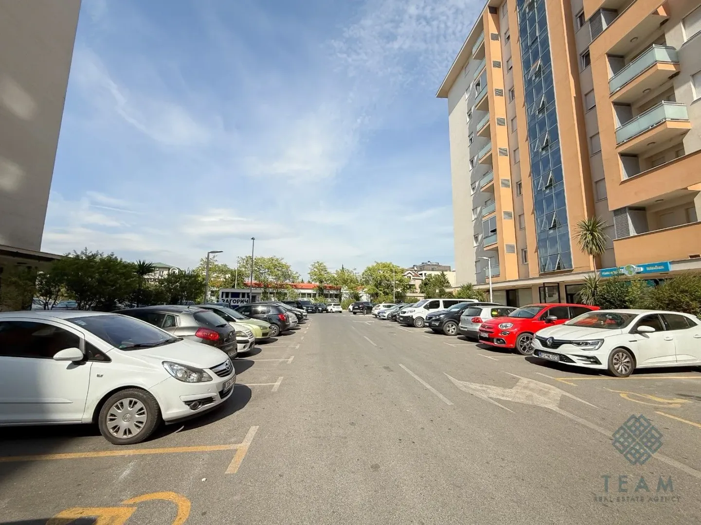 Outdoor area with parking space in front of the residential building.