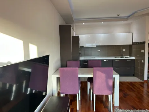 Living room with dining area and a fitted kitchen in the background. - image 3