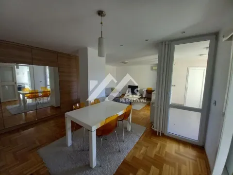 Spacious living room with a dining area and built-in mirrored wardrobes. - image 2
