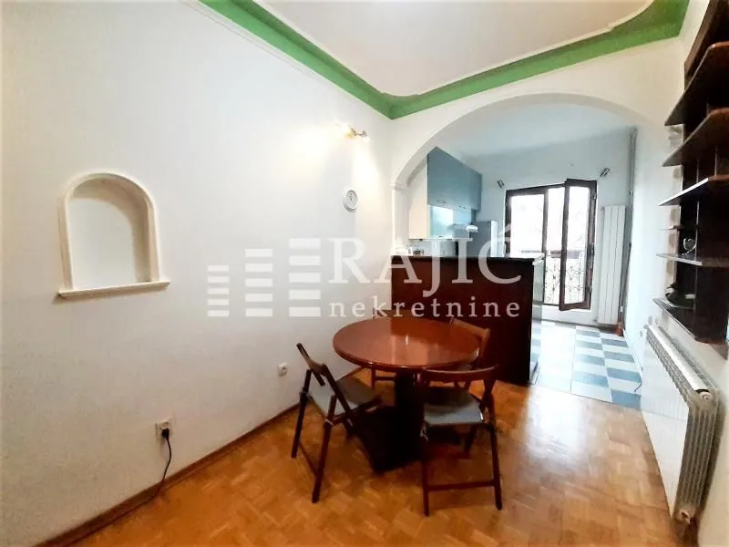 Dining area with a table and chairs, overlooking the kitchen.