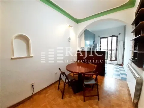 Dining area with a table and chairs, overlooking the kitchen. - image 4