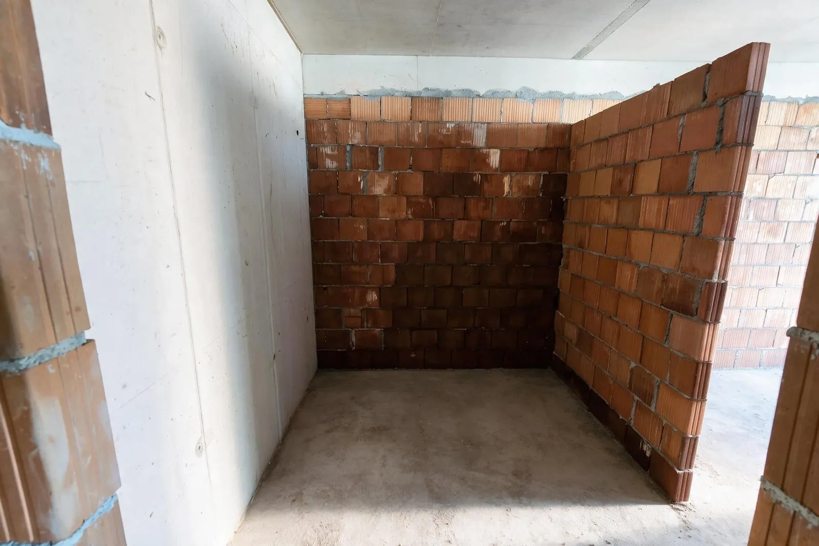 Nepotpun prostor u izgradnji sa betonskim i ciglenim zidovima.